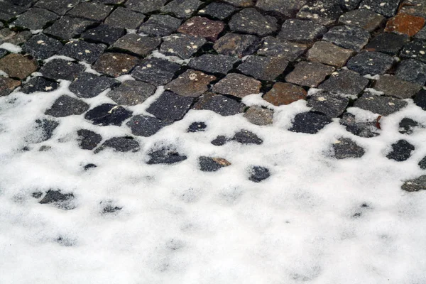 Snow on old stone pavement. — Stock Photo, Image