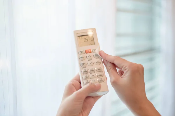 woman is cleaning remote control in house