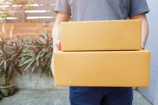 Close up man is holding delivery box at home