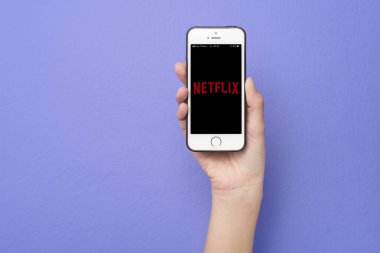 Bangkok, THAILAND, 14 Haziran 2020: Apple iPhone SE üzerinde Netflix logosu olan akıllı telefonu tutan kadın