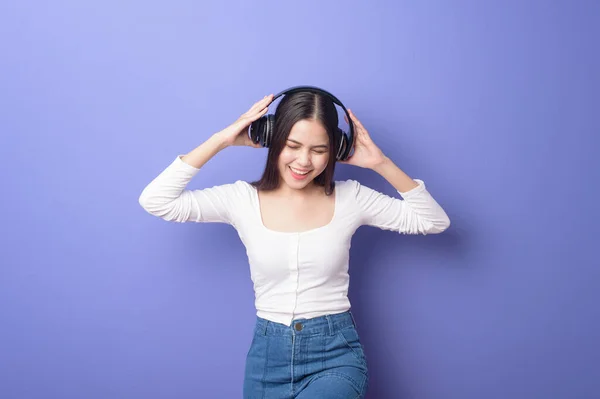 Jovem Mulher Está Ouvindo Música Fundo Roxo — Fotografia de Stock