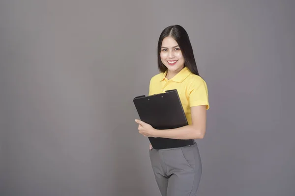 Young Confident Beautiful Woman Wearing Yellow Shirt Holding Documents Grey — Stock Photo, Image