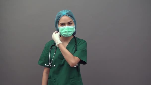 Portrait of Happy Young Doctor woman in green scrubs uniform on gray background — Stock Video