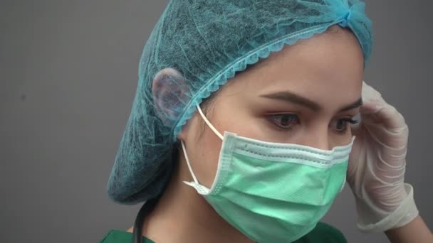 Portrait of young woman doctor in uniform green scrubs feeling down and very tired with pandemic covid-19 — Stock Video