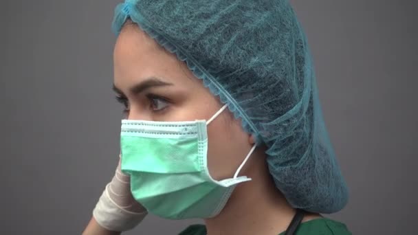 Portrait of young woman doctor in uniform green scrubs feeling down and very tired with pandemic covid-19 — Stock Video