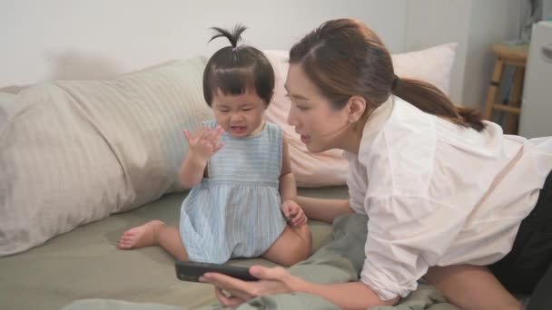 Asian Mother Her Baby Daughter Making Selfie Video Call Father — стоковое видео