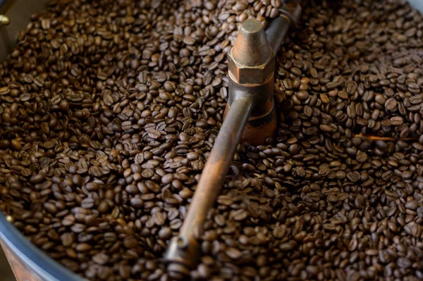 Coffee beans is roasting in roaster machine in coffee shop.