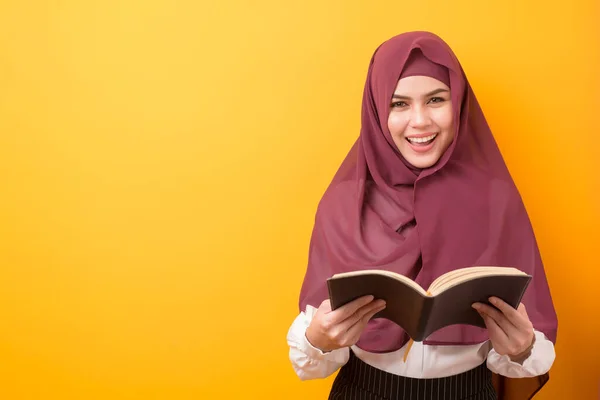 Beautiful University student with hijab portrait on yellow background