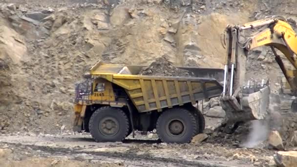 Hydraulic Excavator Loads Blasted Rock Belaz — Stock Video