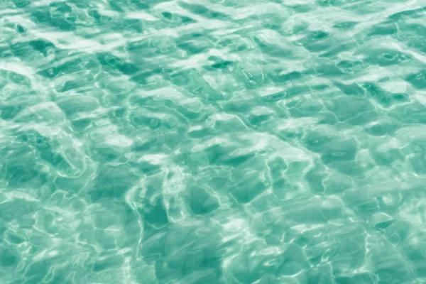 Turquoise water surface. Glare on the sea surface