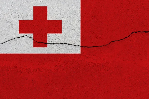 Tonga flag on concrete wall with crack