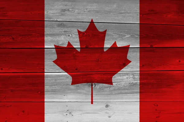 Canada flag painted on old wood plank