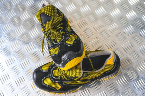 Unbranded modern sneaker in the gym. Black-Yellow. Comfortable shoes.
