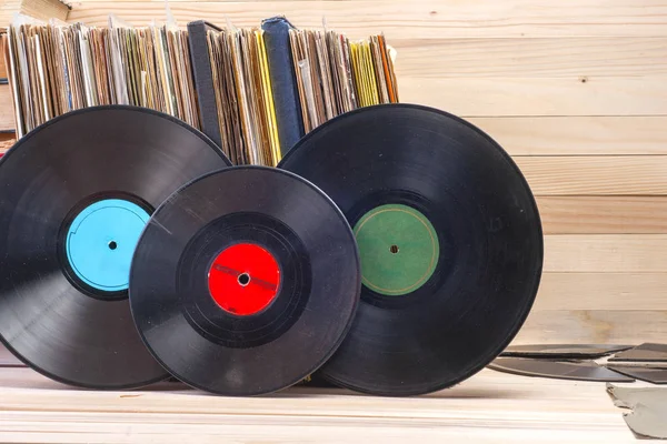 Vinyl record in front of a collection of albums, vintage process. Copy space for text — Stock Photo, Image