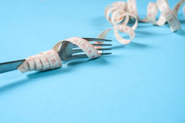 çatal ile santimetre bir mavi arka plan, diyet, sağlıklı yaşam tarzı.