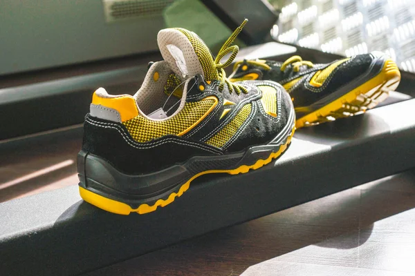 Unbranded modern sneaker in the gym. Black-Yellow. Comfortable shoes.