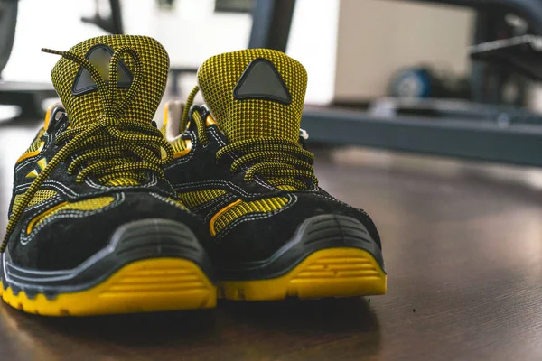 Unbranded modern sneaker in the gym. Black-Yellow. Comfortable shoes.