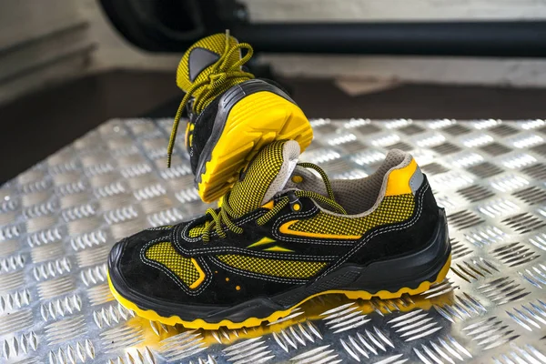 Unbranded modern sneaker in the gym. Black-Yellow. Comfortable shoes.