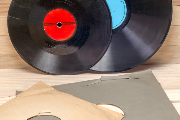 Vinyl record in front of a collection of albums, vintage process. Copy space for text — Stock Photo, Image