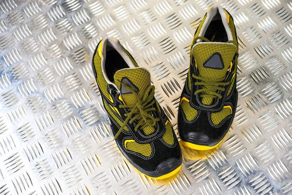 Unbranded modern sneaker in the gym. Black-Yellow. Comfortable shoes.