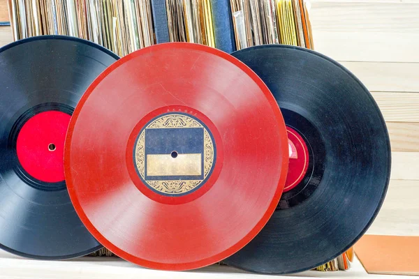 Vinyl record in front of a collection of albums, vintage process. Copy space for text — Stock Photo, Image