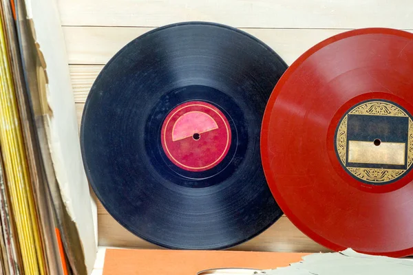 Vinyl record in front of a collection of albums, vintage process. Copy space for text — Stock Photo, Image