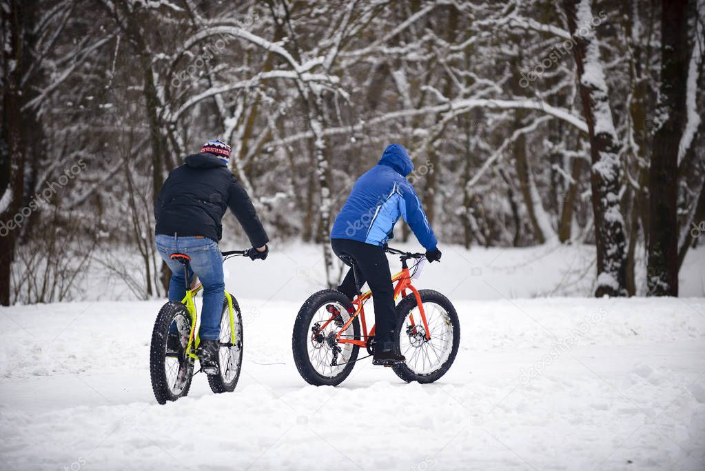 cyclist in winter on a bicycle with very wide wheels