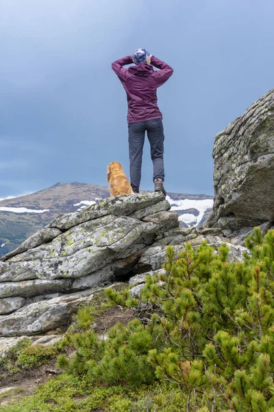 girl with a dog in the mountains, Carpathians, Ukraine. May 2017