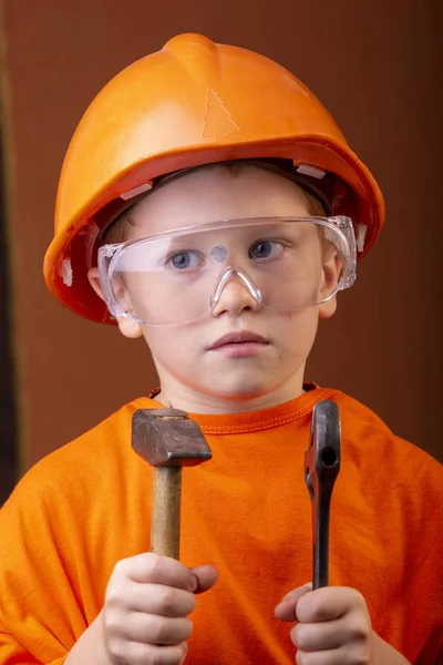 boy builder in an orange helmet