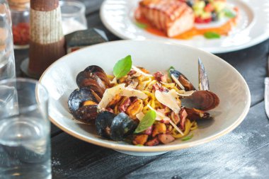 Ahşap masa üzerinde taze salata ile midye görünümü Kapat