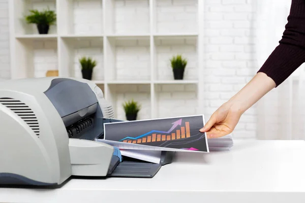 Woman hand using printer in office