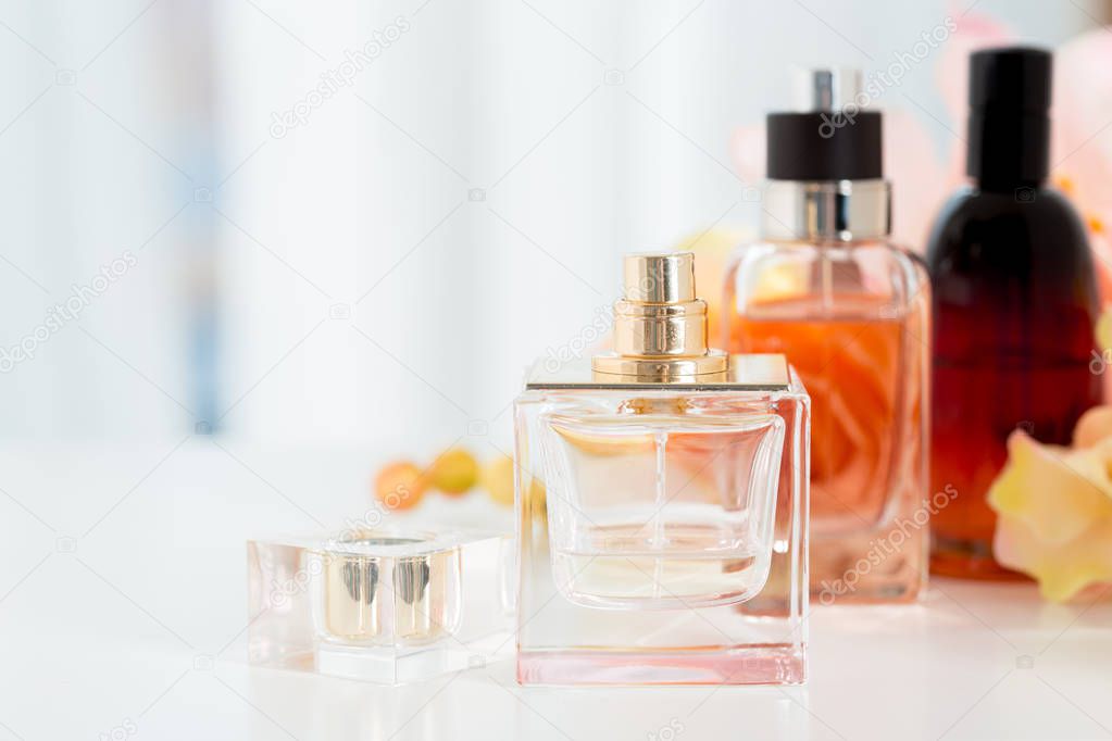 Perfume bottles on flowers background