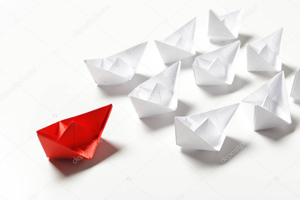 Origami paper ships isolated on white background
