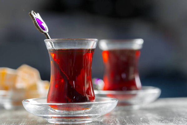 Red tea in turkish glasses on wooden table
