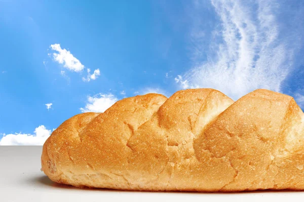 桌上有蓝天背景的面包 — 图库照片