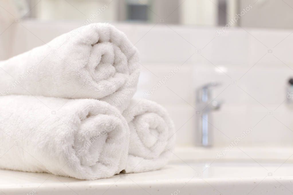 Stack of bath towels on light background