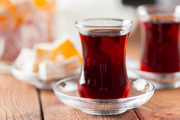 Red tea in turkish glasses on a wooden table