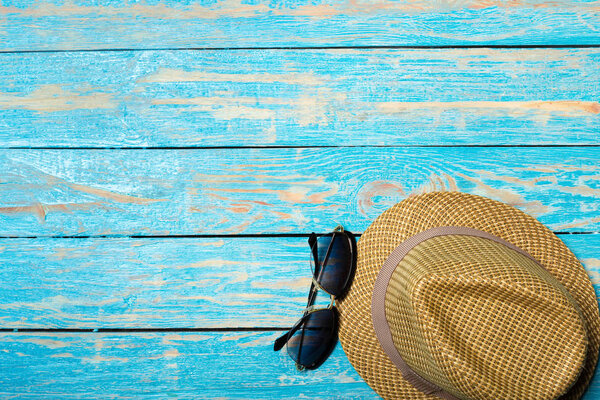 Beach accessories on blue wooden board