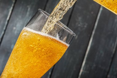 Ahşap arka planda bir bardak bira