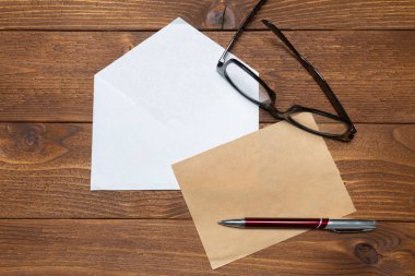 Boş kağıt, zarf üzerinde ahşap masa