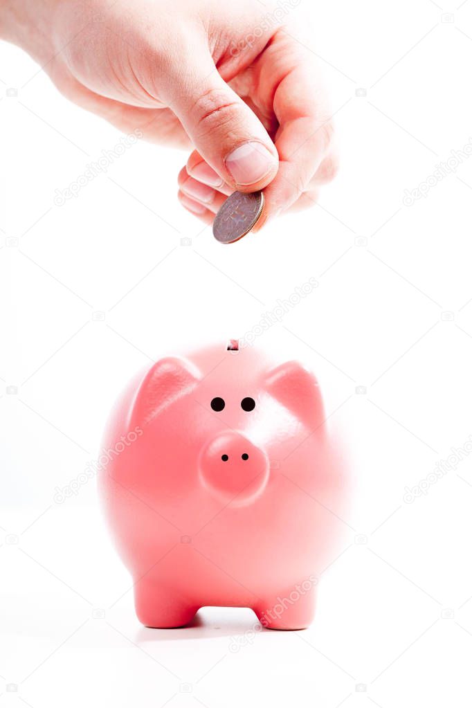 Savings concept, Piggy bank and hand with coin