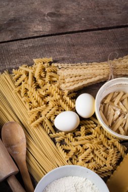 Makarna spagetti eski ahşap arka plan üzerine un, yumurta