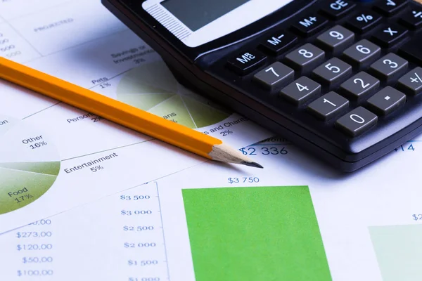 Business charts and graphs with Calculator, close-up