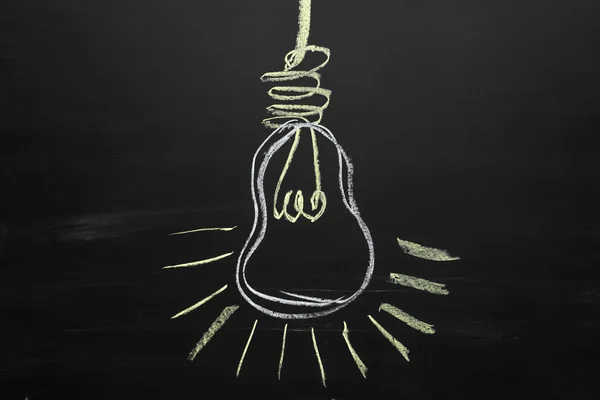 Idea Light Bulb on Blackboard. Business concept