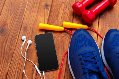 Spor ayakkabı, ahşap arka plan üzerinde dumbbells ile Fitness kavramı