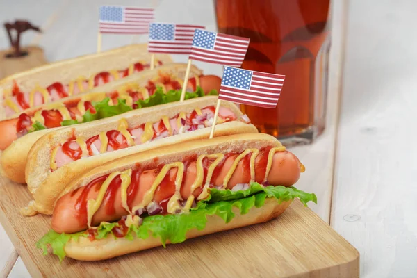 Hot dogs with usa flags on wooden background