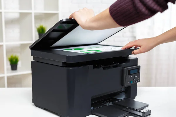 person using printer in office, close up