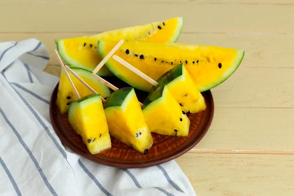 Sliced yellow watermelon on plate
