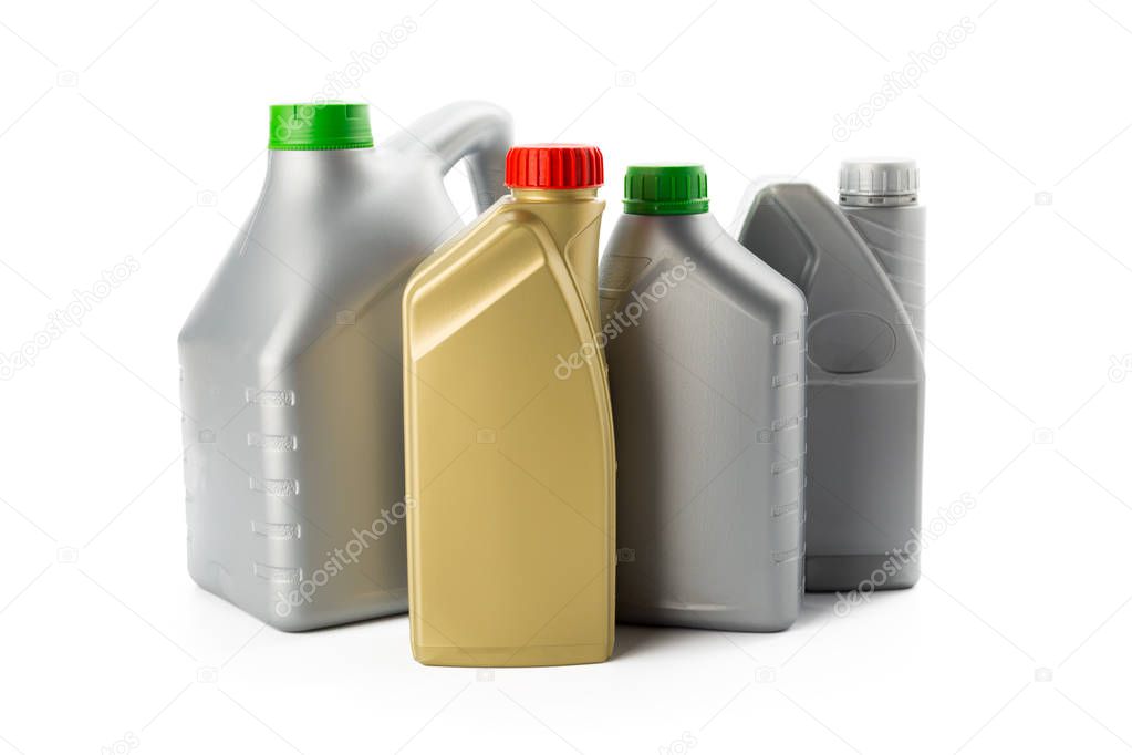 Plastic bottles from automobile oils isolated on white background, close-up 