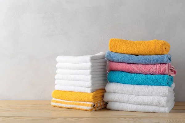 clean spa towels on wooden surface